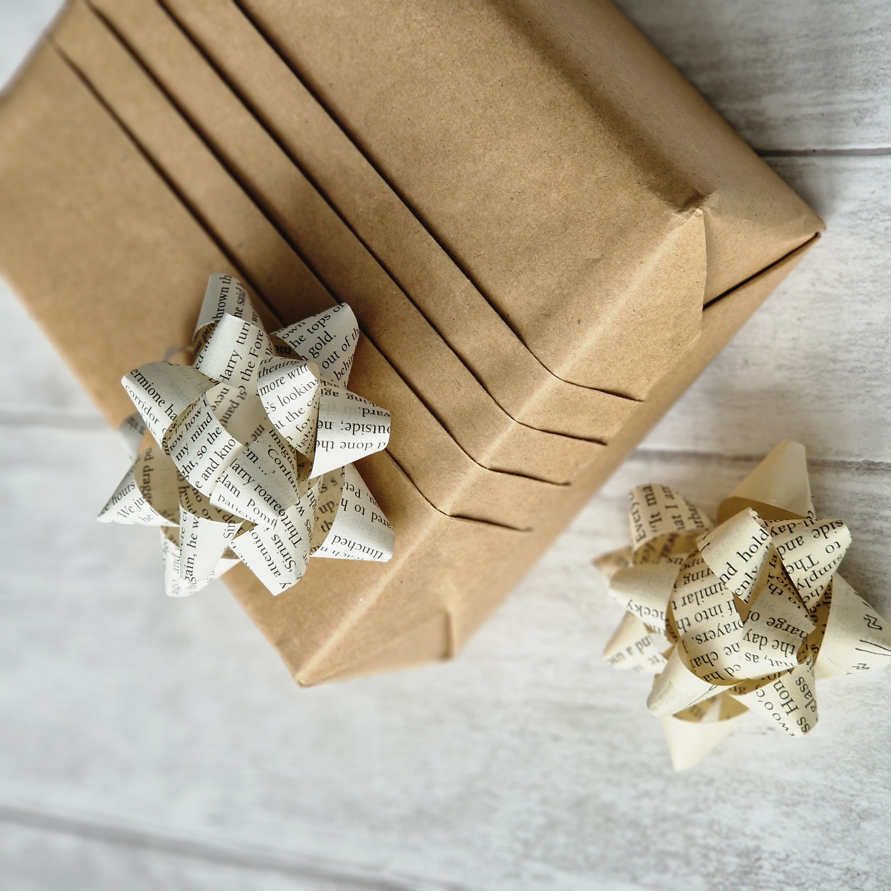 Pleated brown paper gift wrap box with a star bow made from book paper on top