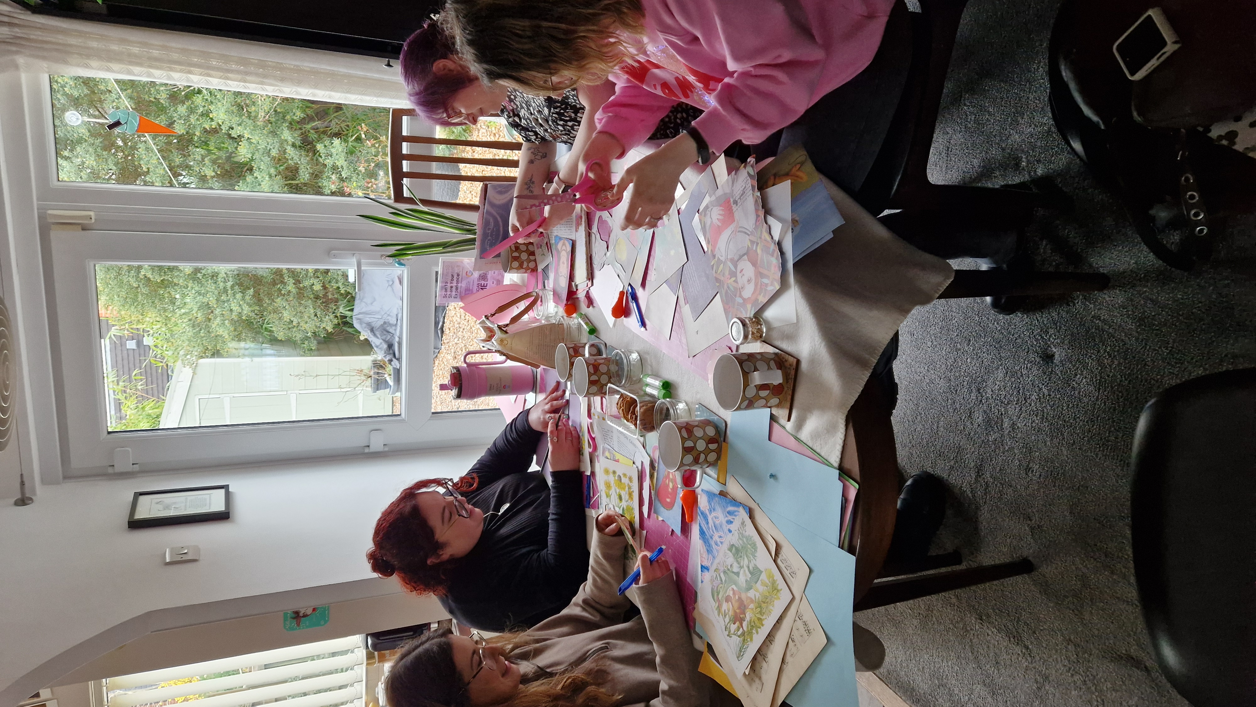 A  private party of women in their 30s are crafting at a table at Retro from Scratch HQ