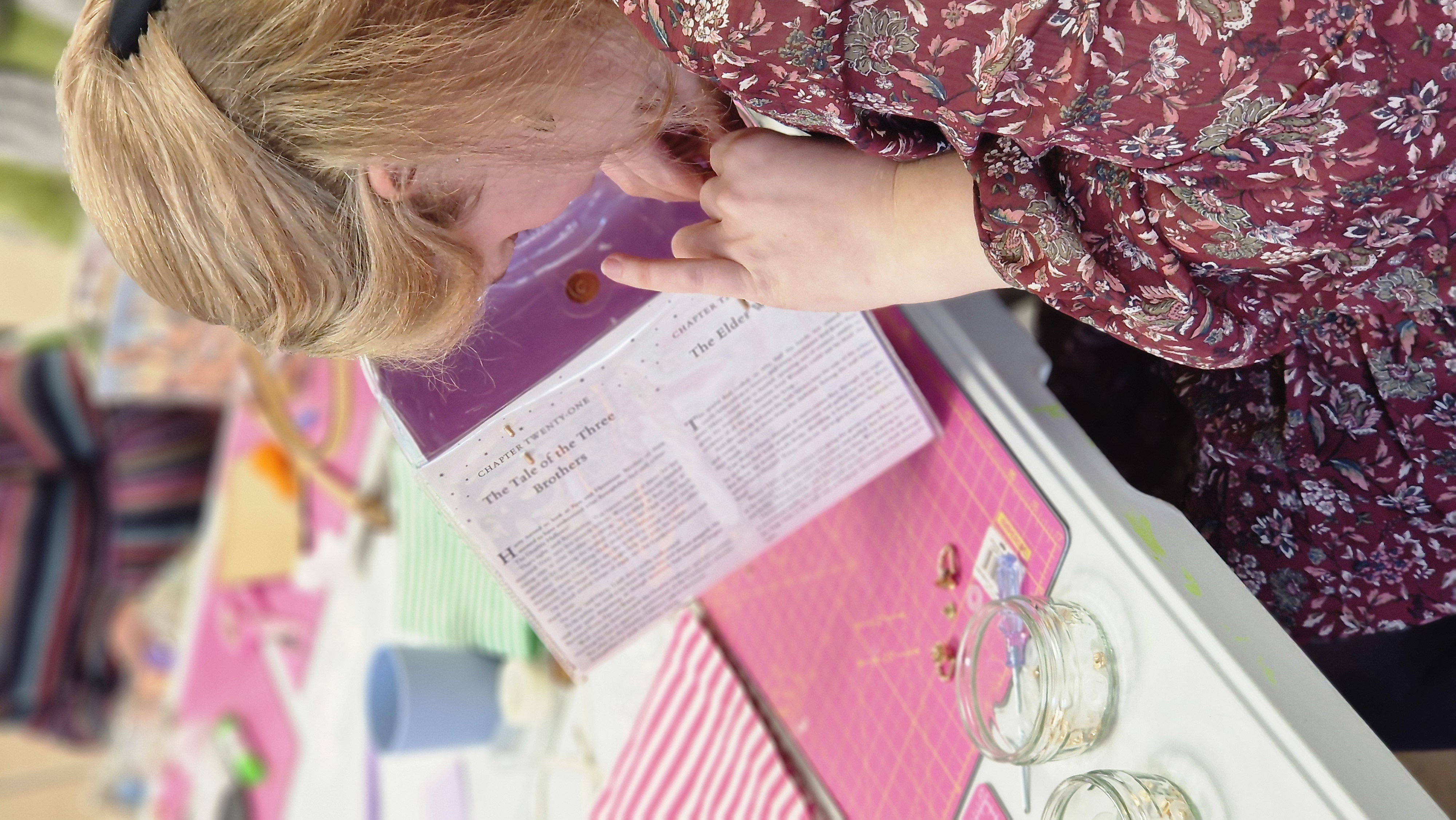 Woman in her thirties is crafting a handbag made from old books